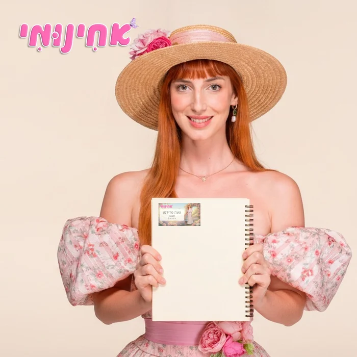 אחינומי מחזיקה מחברת עם מדבקת שם אישית
